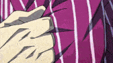 a close up of a person 's hand on a striped shirt