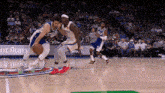 a basketball game is being played on a court with a sign that says ' ent runs ' on it