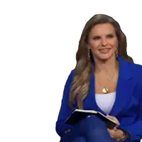a woman in a blue jacket is smiling and holding a book