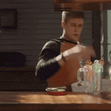 a man sitting at a table with a can of sardines