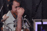 a man wearing headphones is drinking from a bottle that says kronenbourg on it