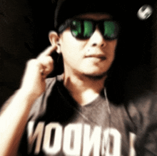 a man wearing sunglasses and a t-shirt that says " woo "