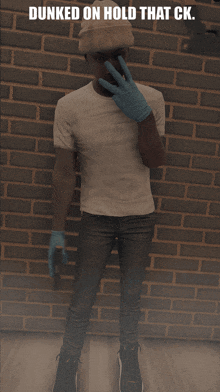 a man in a white shirt and blue gloves covering his nose with his hand