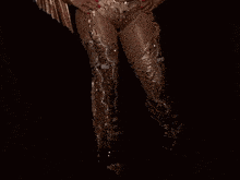 a woman is wearing a cowboy outfit with fringe and a belt that says ' cowboy ' on it