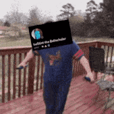 a man standing on a deck with a sign that says lestin the ballscholar on it