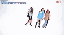 a group of women are dancing in front of a white background and the words welcome to my world are on the screen .