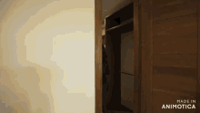 a wooden door is open to a closet with the words made in animatica on the bottom