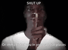 a man is holding his finger to his mouth and says shut up or imma ticket you in your special places