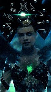 a woman with a shield on her head has a green light shining on her face