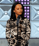 a woman in a leopard print shirt is standing in front of a microphone with a t4yce tumblr watermark