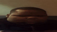 a close up of a man 's face with a serious look on his face