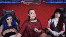 three women are sitting in front of a screen that says big dragon on it
