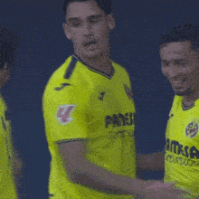 a man wearing a yellow shirt that says pamesa