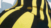 a close up of a yellow and black striped dress