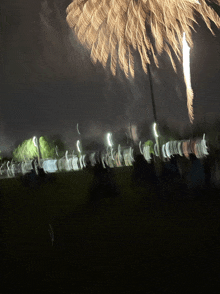 a blurry picture of a fireworks display in a field