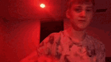 a young man is holding a piece of food in his hands in a dark room .