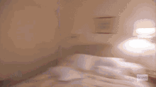 a blurry picture of a bed with bravo on the bottom right