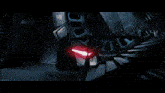 a pixelated image of a person in a dark room with a glowing object in the background