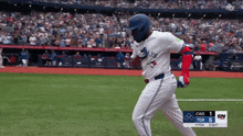a blue jays baseball player runs towards home plate