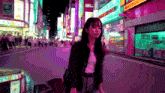 a woman walking down a city street with a sign that says ' a ' on it