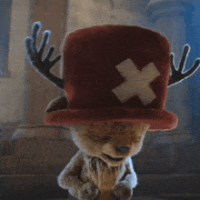 a reindeer with antlers wearing a red hat with an x on it