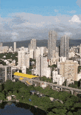 an aerial view of a city with tall buildings and trees