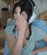 a woman wearing headphones with the letters steelseries on them