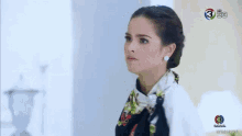 a man in a tuxedo and a woman in a white dress are looking at each other .