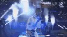 a man in a white shirt is standing in front of a microphone with the words madridistas written on the screen behind him
