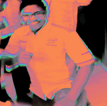 a man wearing a purple shirt with the intel logo on it