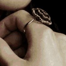 a woman wearing a ring on her left hand