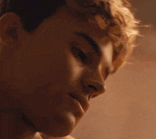 a close up of a young man 's face with his eyes closed and his mouth open