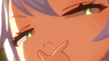 a close up of a girl 's face with a hand covering her nose