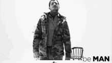 a black and white photo of a man with the words " be man " on the bottom