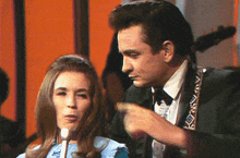 a man and a woman are talking into microphones