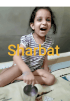 a little girl is sitting on a bed with sharbat written in yellow