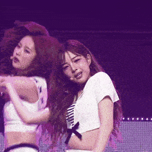 a girl in a white crop top is dancing on stage