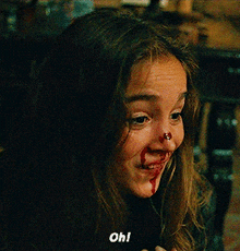 a girl with blood on her nose is smiling and says oh