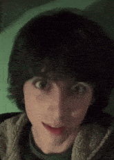a close up of a person 's face with a surprised look on his face