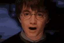 a close up of harry potter wearing glasses with his eyes closed .