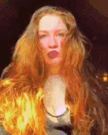 a pixelated image of a woman 's face with long red hair