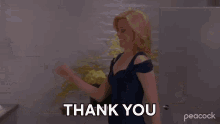 a woman in a blue dress says thank you
