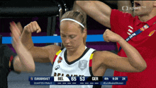 a female basketball player is flexing her muscles during a game