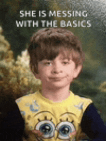 a young boy wearing a yellow spongebob shirt is smiling and says she is messing with the basics .