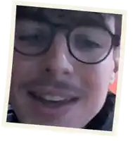 a close up of a man wearing glasses and smiling in a polaroid frame .
