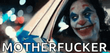 a close up of a clown 's face with the words `` motherfucker '' written below it .