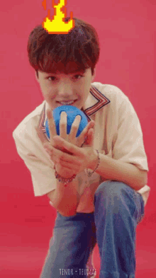 a young man is playing bowling on a red surface
