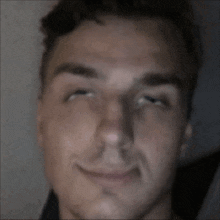 a close up of a man making a funny face with his eyes closed