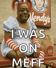 a wendy 's sign is behind a woman in a blue dress