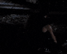 a man wearing a black tank top with a skull on it